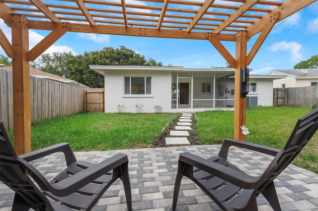 245 Grove Cir N, Dunedin, FL 34698 - fenced backyard featuring a sunroom, a patio area, and a pergola