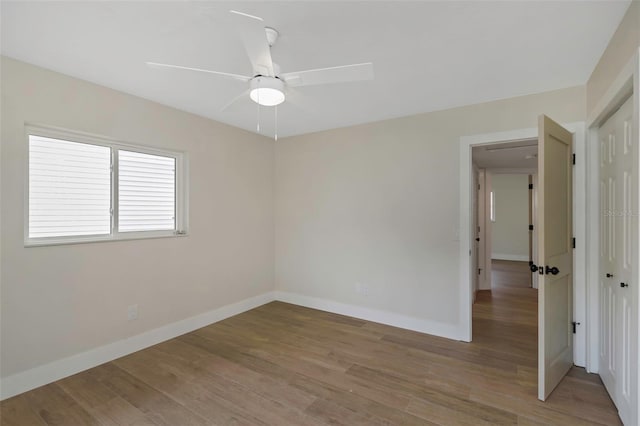 245 Grove Cir N, Dunedin, FL 34698 - empty room featuring a ceiling fan and light wood finished floors