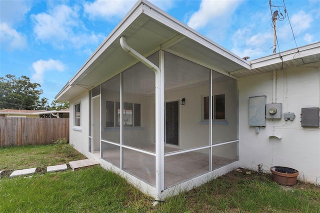 245 Grove Cir N, Dunedin, FL 34698 - back of property with a sunroom and stucco siding