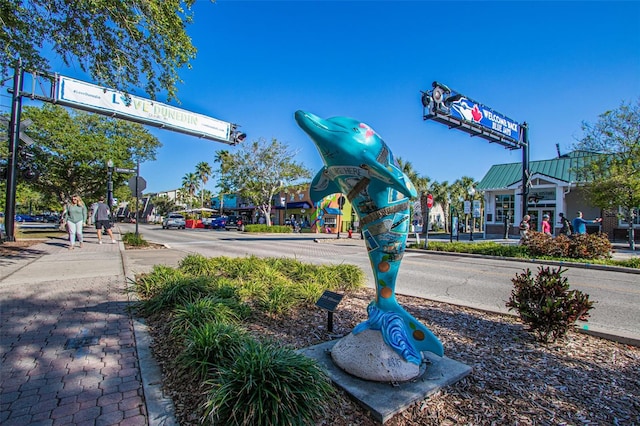 245 Grove Cir N, Dunedin, FL 34698 - view of asphalt road with traffic lights, sidewalks, curbs, and traffic signs