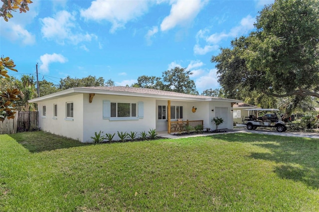 245 Grove Cir N, Dunedin, FL 34698 - ranch-style home with stucco siding and an attached garage