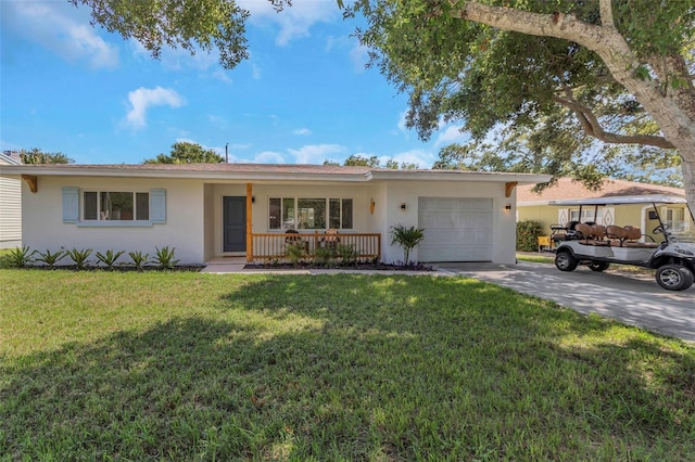 245 Grove Cir N, Dunedin, FL 34698 - ranch-style house featuring stucco siding, an attached garage, a porch, and concrete driveway