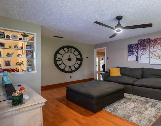 616 Pawn Way, Seffner, FL 33584 - living room with light wood-style flooring, a textured ceiling, and ceiling fan