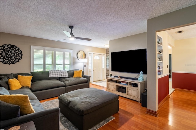 616 Pawn Way, Seffner, FL 33584 - living area with light wood-style floors, a textured ceiling, and a ceiling fan