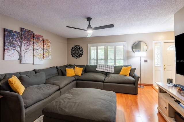 616 Pawn Way, Seffner, FL 33584 - living area featuring a textured ceiling, light wood finished floors, and a ceiling fan