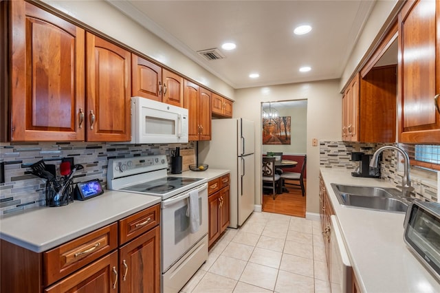 616 Pawn Way, Seffner, FL 33584 - kitchen featuring white appliances, ornamental molding, tasteful backsplash, light countertops, and light tile patterned floors