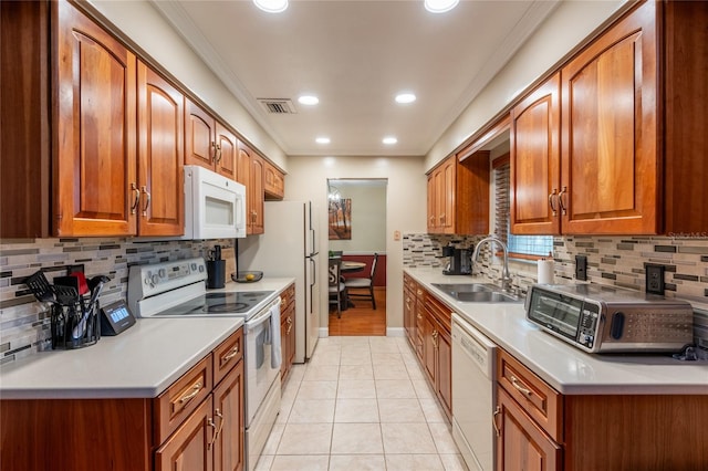 616 Pawn Way, Seffner, FL 33584 - kitchen featuring white appliances, backsplash, brown cabinetry, crown molding, and recessed lighting