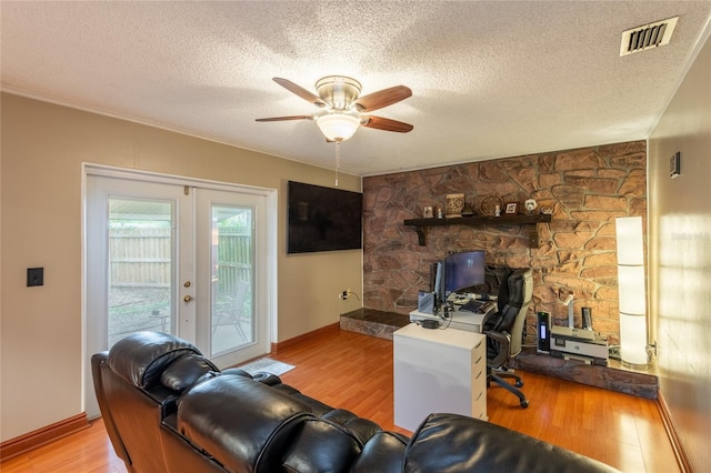 616 Pawn Way, Seffner, FL 33584 - living area featuring wood finished floors, a ceiling fan, a textured ceiling, and french doors