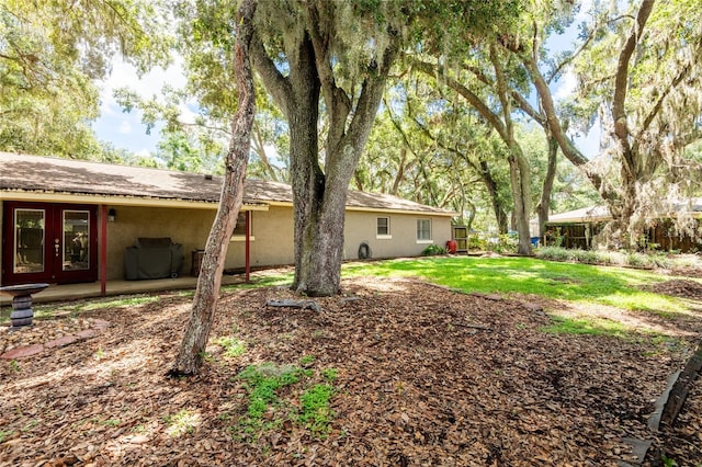 616 Pawn Way, Seffner, FL 33584 - view of green lawn with french doors and a patio area