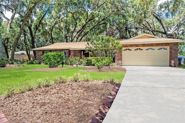 616 Pawn Way, Seffner, FL 33584 - ranch-style house with stone siding, concrete driveway, an attached garage, and a front lawn