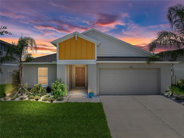 12931 Twin Bridges Dr, Riverview, FL 33579 - view of front of home featuring board and batten siding, driveway, a garage, and stucco siding