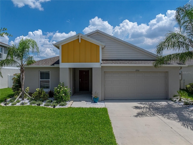 12931 Twin Bridges Dr, Riverview, FL 33579 - view of front of property with a garage, concrete driveway, board and batten siding, a front yard, and stucco siding