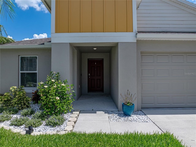 12931 Twin Bridges Dr, Riverview, FL 33579 - entrance to property with stucco siding, a shingled roof, and board and batten siding