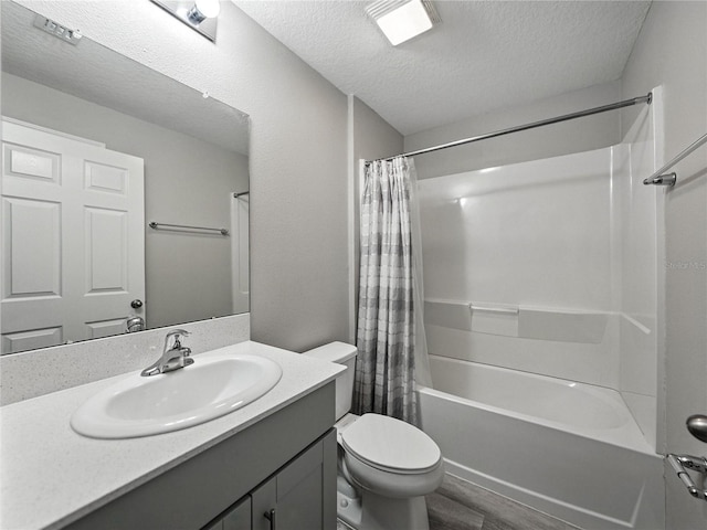 12931 Twin Bridges Dr, Riverview, FL 33579 - full bath with a textured ceiling, vanity, wood finished floors, and shower / bath combo