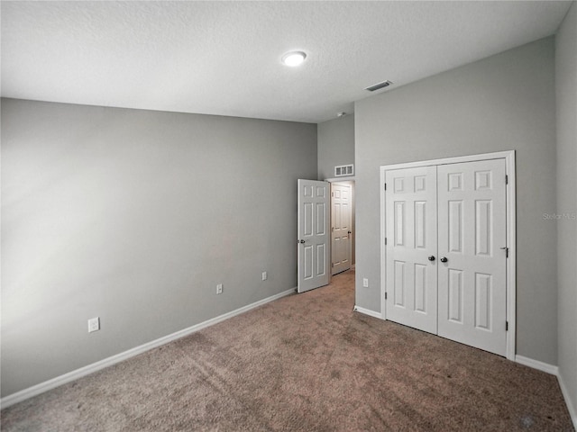 12931 Twin Bridges Dr, Riverview, FL 33579 - unfurnished bedroom featuring carpet flooring, a closet, and a textured ceiling