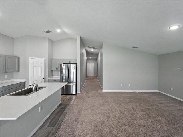 12931 Twin Bridges Dr, Riverview, FL 33579 - kitchen featuring stainless steel fridge, gray cabinetry, light countertops, recessed lighting, and dark carpet