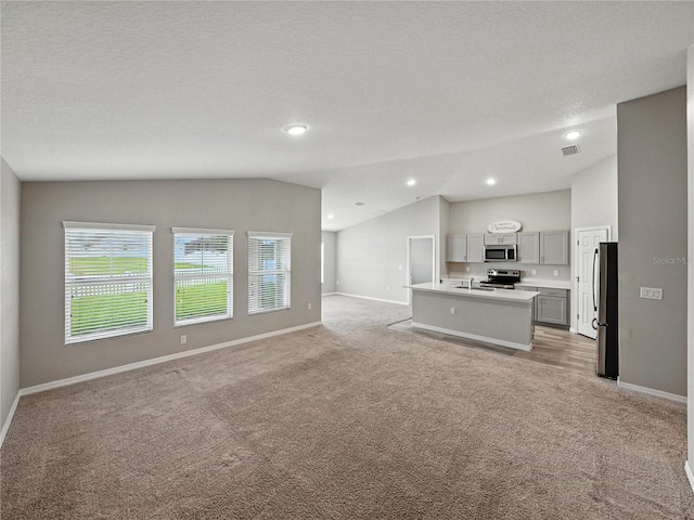 12931 Twin Bridges Dr, Riverview, FL 33579 - unfurnished living room with light carpet, vaulted ceiling, and recessed lighting