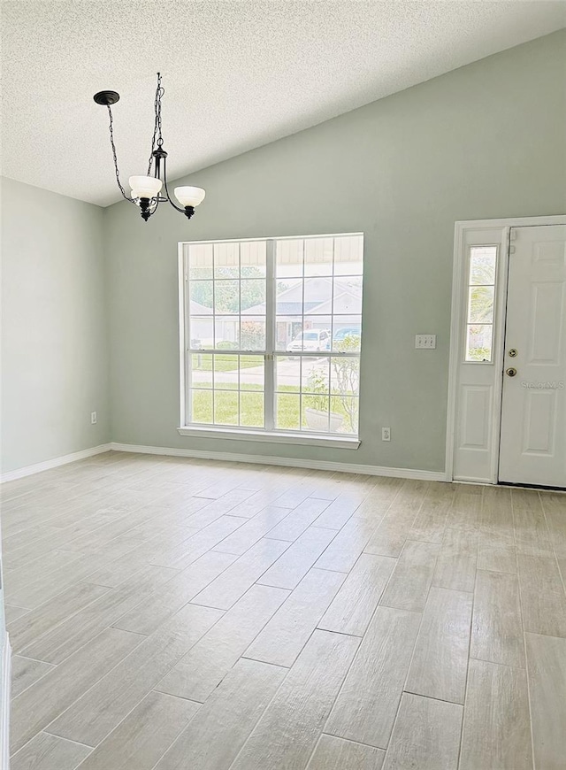 1990 Eclipse Dr, Middleburg, FL 32068 - unfurnished room with healthy amount of natural light, a chandelier, a textured ceiling, and light wood finished floors