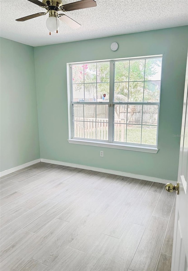 1990 Eclipse Dr, Middleburg, FL 32068 - empty room featuring wood finished floors, a textured ceiling, and a ceiling fan