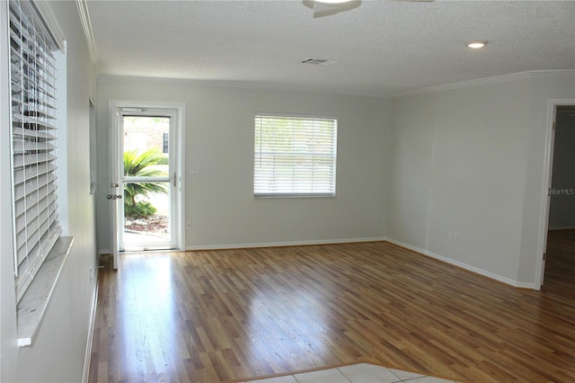 6144 Elmhurst Dr, New Port Richey, FL 34653 - empty room featuring wood finished floors, ornamental molding, and a textured ceiling