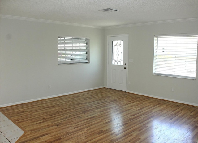 6144 Elmhurst Dr, New Port Richey, FL 34653 - foyer entrance featuring crown molding, wood finished floors, and a textured ceiling