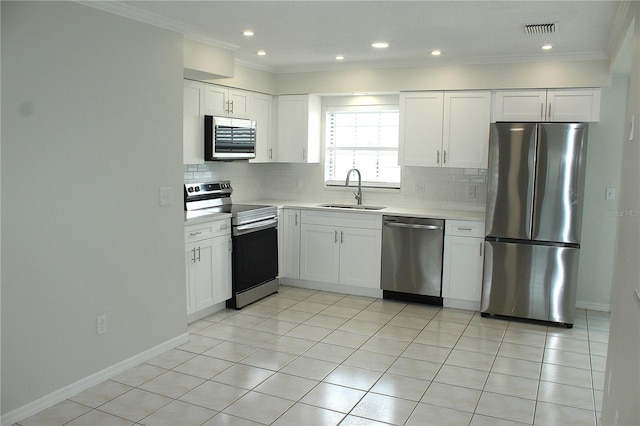 6144 Elmhurst Dr, New Port Richey, FL 34653 - kitchen featuring stainless steel appliances, light countertops, decorative backsplash, white cabinetry, and ornamental molding