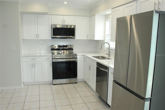 6144 Elmhurst Dr, New Port Richey, FL 34653 - kitchen with stainless steel appliances, crown molding, light countertops, white cabinets, and recessed lighting