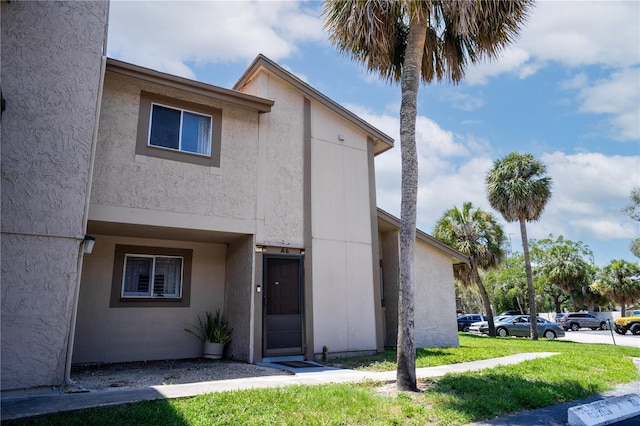 6338 Newtown Cir Unit 38A6, Tampa, FL 33615 - townhome / multi-family property featuring stucco siding and a front lawn