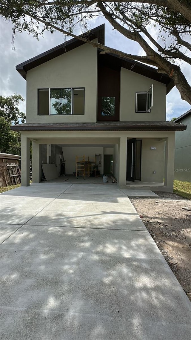 12236 Land St, Largo, FL 33773 - view of front of house with concrete driveway and stucco siding
