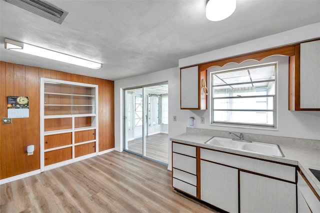 4911 Bartelt Rd, Holiday, FL 34690 - kitchen with light wood-type flooring, light countertops, and built in features
