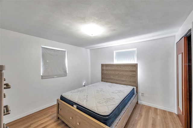 4911 Bartelt Rd, Holiday, FL 34690 - bedroom featuring light wood-style flooring