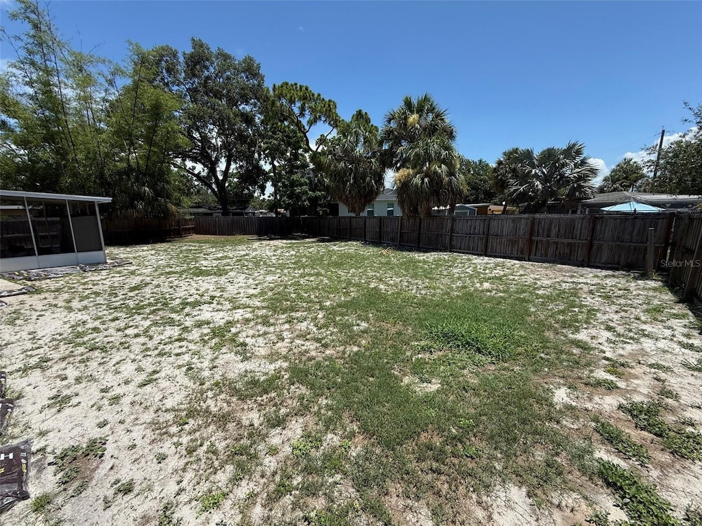 2907 W Elrod Ave, Tampa, FL 33611 - fenced backyard with a sunroom