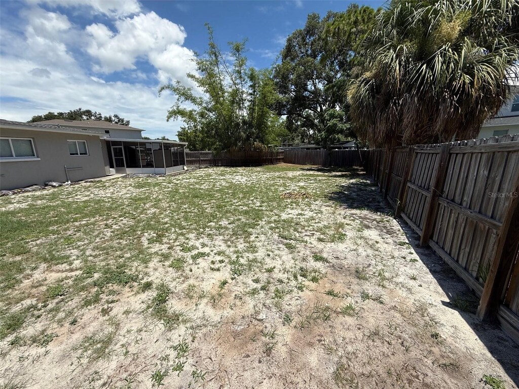 2907 W Elrod Ave, Tampa, FL 33611 - fenced backyard featuring a sunroom