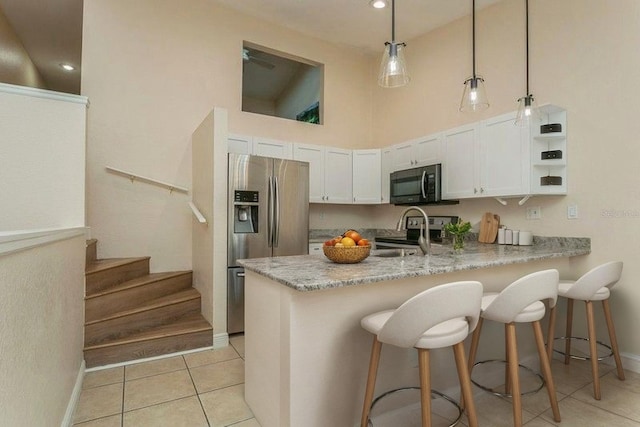 6263 93rd Ter N Unit 4202, Pinellas Park, FL 33782 - kitchen featuring black microwave, stainless steel fridge, range, a high ceiling, and a peninsula