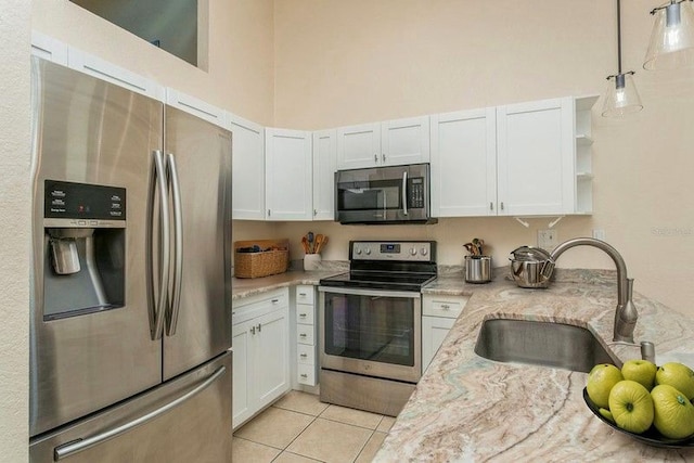 6263 93rd Ter N Unit 4202, Pinellas Park, FL 33782 - kitchen with stainless steel appliances, open shelves, white cabinetry, and a towering ceiling