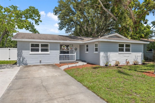 8897 54th St N, Pinellas Park, FL 33782 - view of front of house featuring covered porch, roof with shingles, stone siding, and driveway