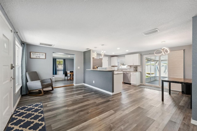 8897 54th St N, Pinellas Park, FL 33782 - kitchen featuring appliances with stainless steel finishes, a chandelier, dark wood finished floors, white cabinetry, and a textured ceiling