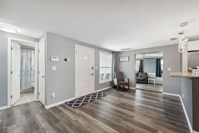 8897 54th St N, Pinellas Park, FL 33782 - entrance foyer with a textured ceiling and dark wood finished floors