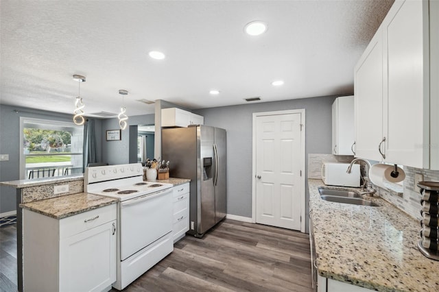 8897 54th St N, Pinellas Park, FL 33782 - kitchen featuring white appliances, a peninsula, white cabinetry, dark wood-style flooring, and recessed lighting