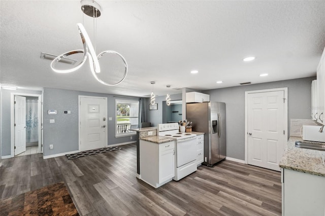 8897 54th St N, Pinellas Park, FL 33782 - kitchen featuring electric stove, stainless steel fridge, white cabinets, dark wood finished floors, and recessed lighting