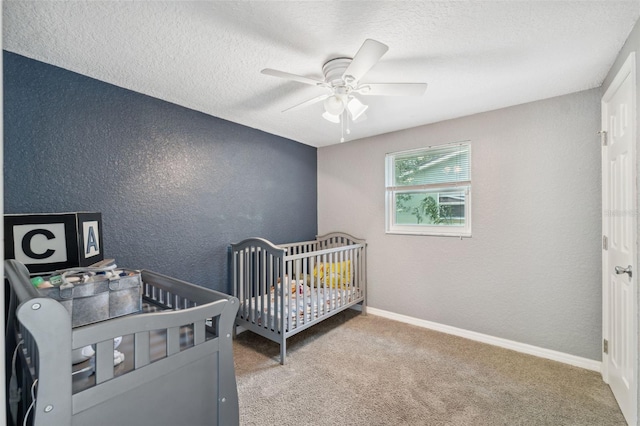 8897 54th St N, Pinellas Park, FL 33782 - carpeted bedroom featuring a textured wall, a textured ceiling, ceiling fan, and a crib