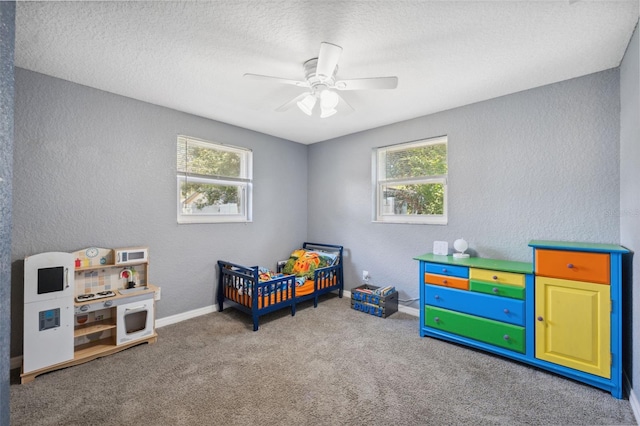 8897 54th St N, Pinellas Park, FL 33782 - bedroom with multiple windows, a textured wall, carpet, ceiling fan, and a textured ceiling