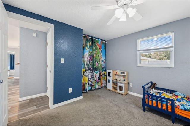 8897 54th St N, Pinellas Park, FL 33782 - bedroom featuring a textured wall, carpet flooring, a ceiling fan, and a textured ceiling