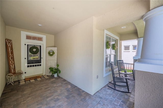 5102 Pheasant Woods Dr, Lutz, FL 33558 - entrance to property featuring stucco siding and covered porch
