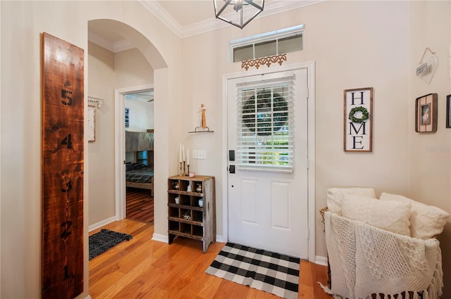 5102 Pheasant Woods Dr, Lutz, FL 33558 - foyer entrance featuring ornamental molding, light wood-style flooring, and arched walkways