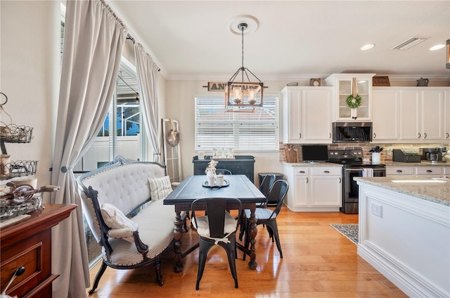5102 Pheasant Woods Dr, Lutz, FL 33558 - dining space featuring light wood-type flooring, ornamental molding, recessed lighting, and a chandelier