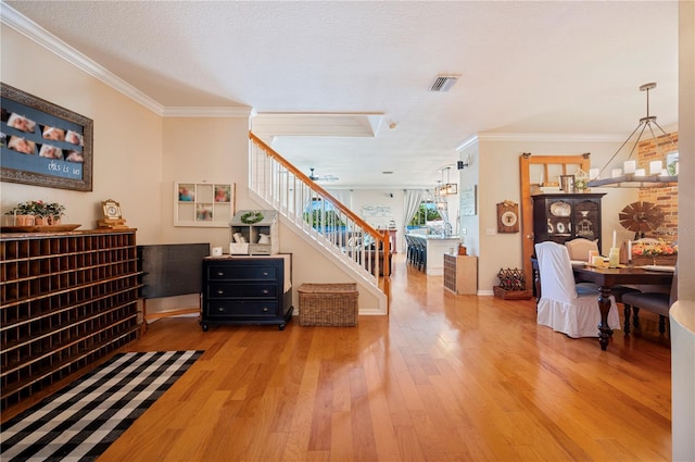 5102 Pheasant Woods Dr, Lutz, FL 33558 - stairs featuring wood finished floors and ornamental molding