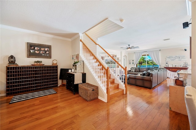 5102 Pheasant Woods Dr, Lutz, FL 33558 - stairs with hardwood / wood-style floors, a ceiling fan, ornamental molding, and a textured ceiling