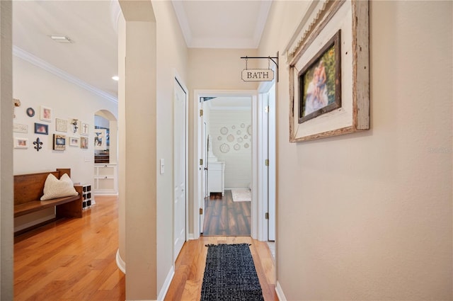 5102 Pheasant Woods Dr, Lutz, FL 33558 - hallway with light wood finished floors, crown molding, and arched walkways