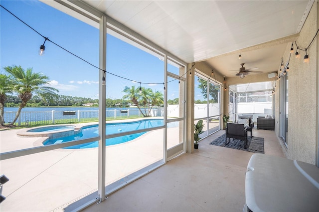 5102 Pheasant Woods Dr, Lutz, FL 33558 - sunroom featuring a jacuzzi, ceiling fan, and a water view